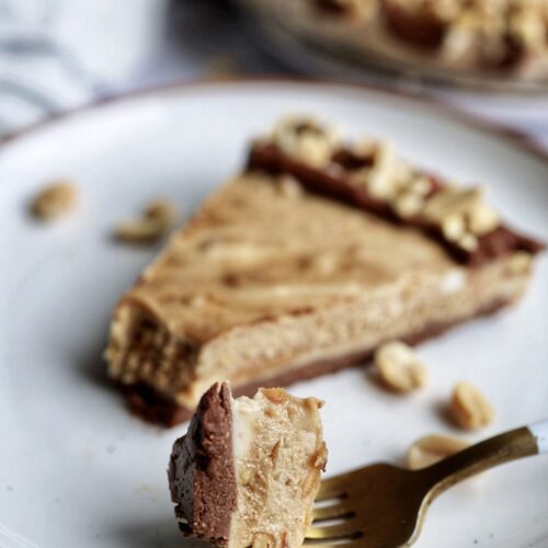 a slice of the peanut butter cup tart on a plate.