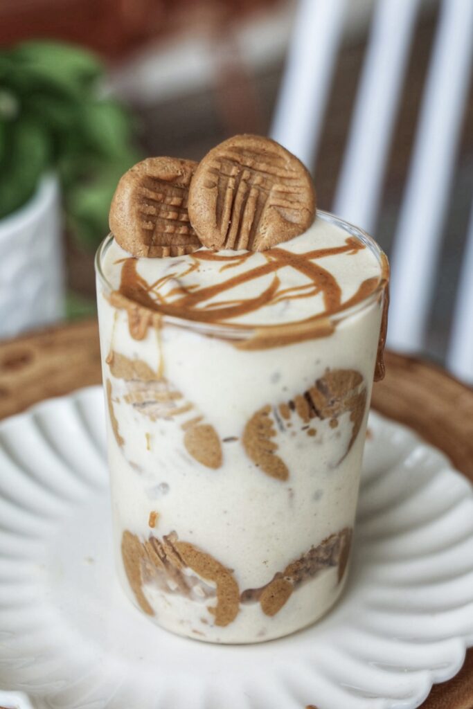 A jar of nutter butter ice cream topped with no-bake peanut butter cookies.