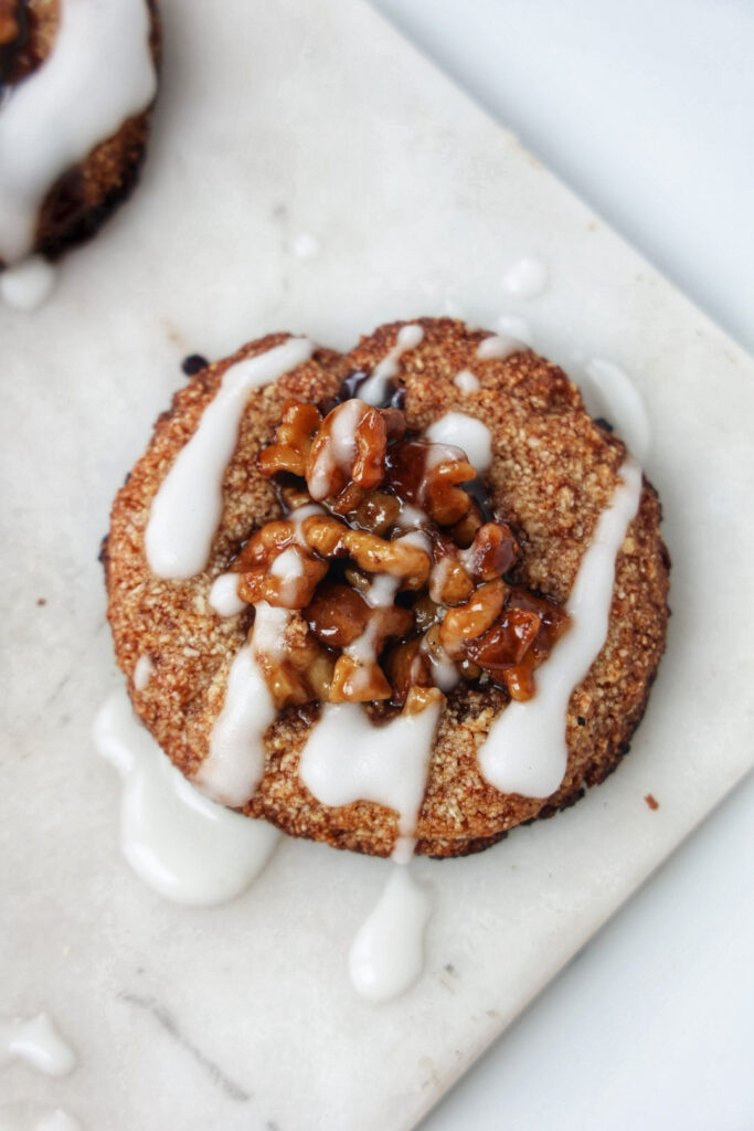 Vegan, paleo, gluten-free cinnamon roll, sticky bun cookies with glaze.