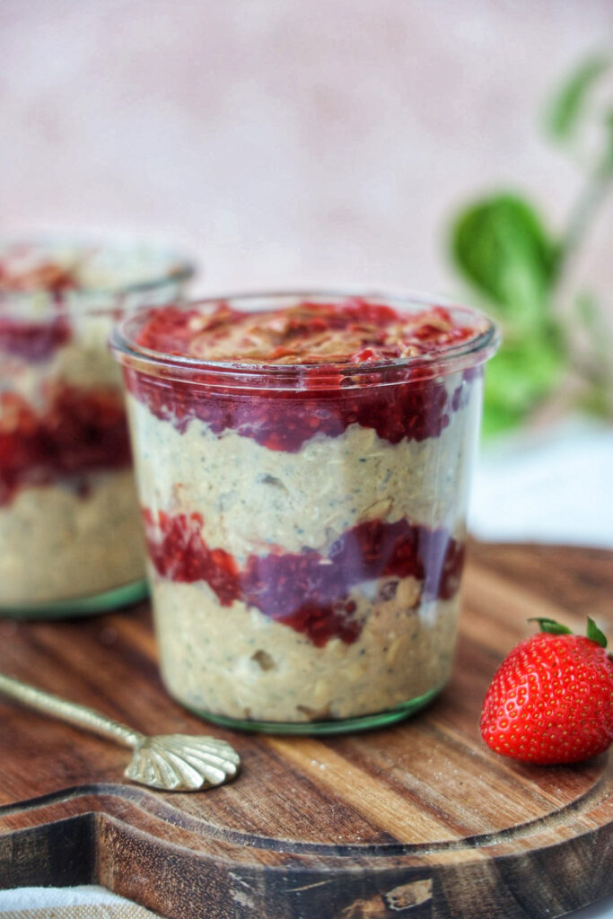 a jar of healthy layered, vegan peanut butter and jelly overnight oats.