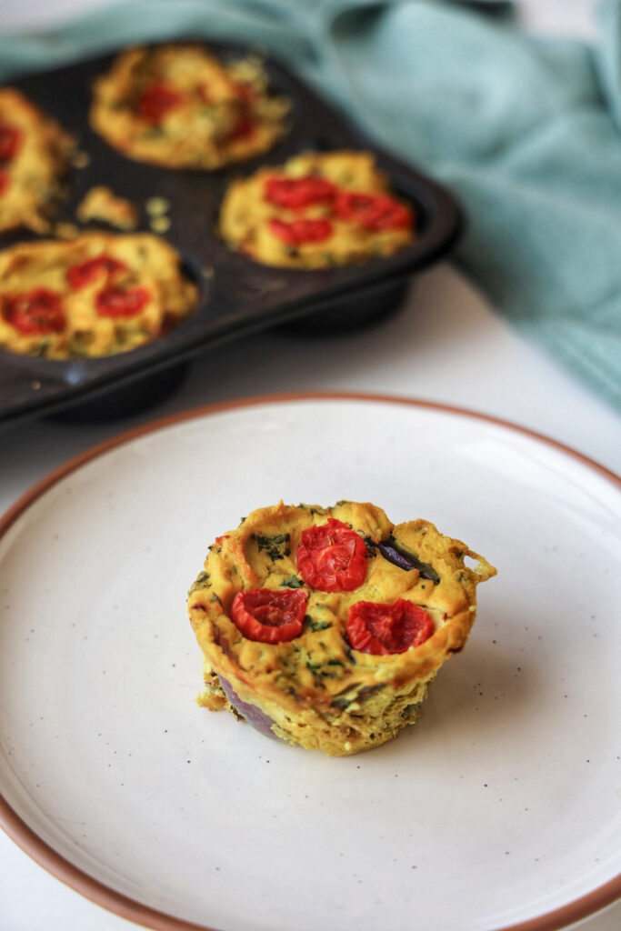 a vegan quiche cup with tomatoes.
