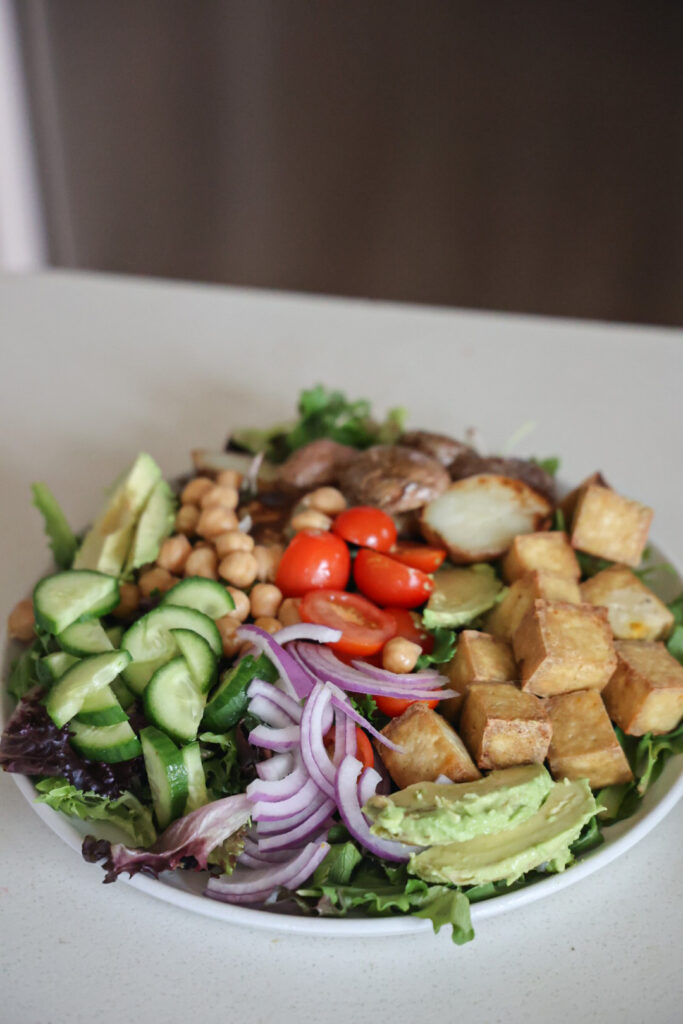 Colorful vegan nicoise salad with air fried tofu and potatoes.