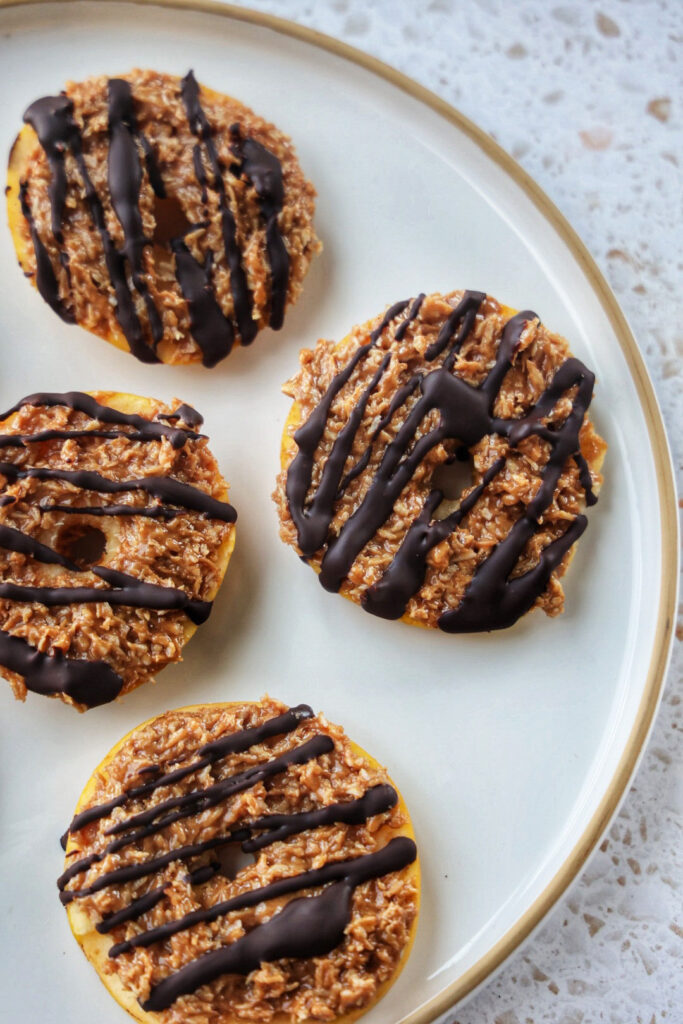 Apple rounds covered in a samoa caramel coconut mixture and drizzled with chocolate.