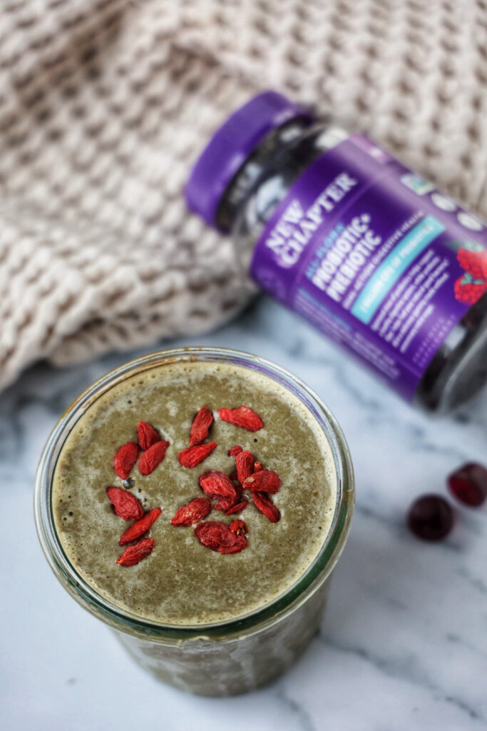 A smoothie next to the new chapter all-flora prebiotic + probiotic supplement.