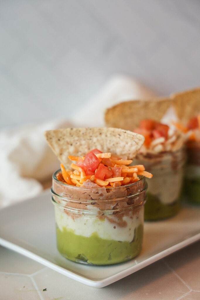 A bunch of 7 layer dip cups.