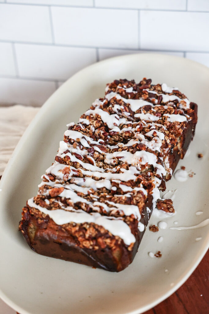 A slice of protein banana bread with streusel topping and glaze.