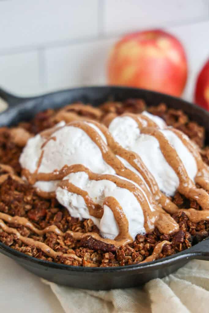 Healthy, vegan caramel apple crisp with ice cream.