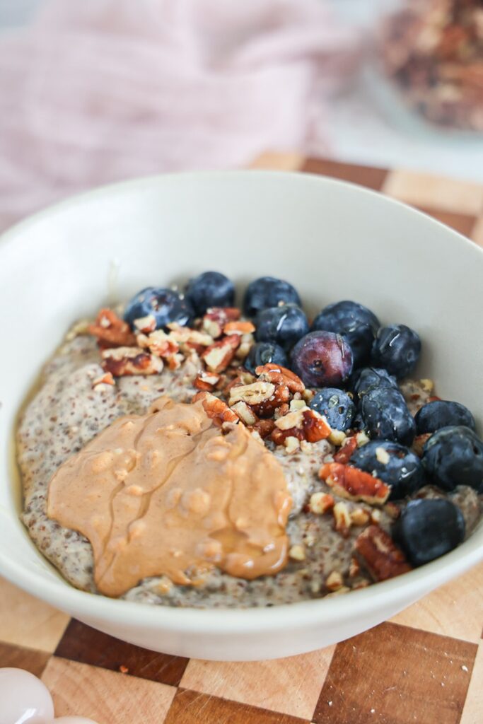 Creamy, warm chia and flax pudding with blueberries, nuts, and nut butter.